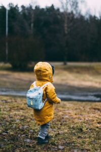 back to school, shallow focus photo of toddler walking near river
